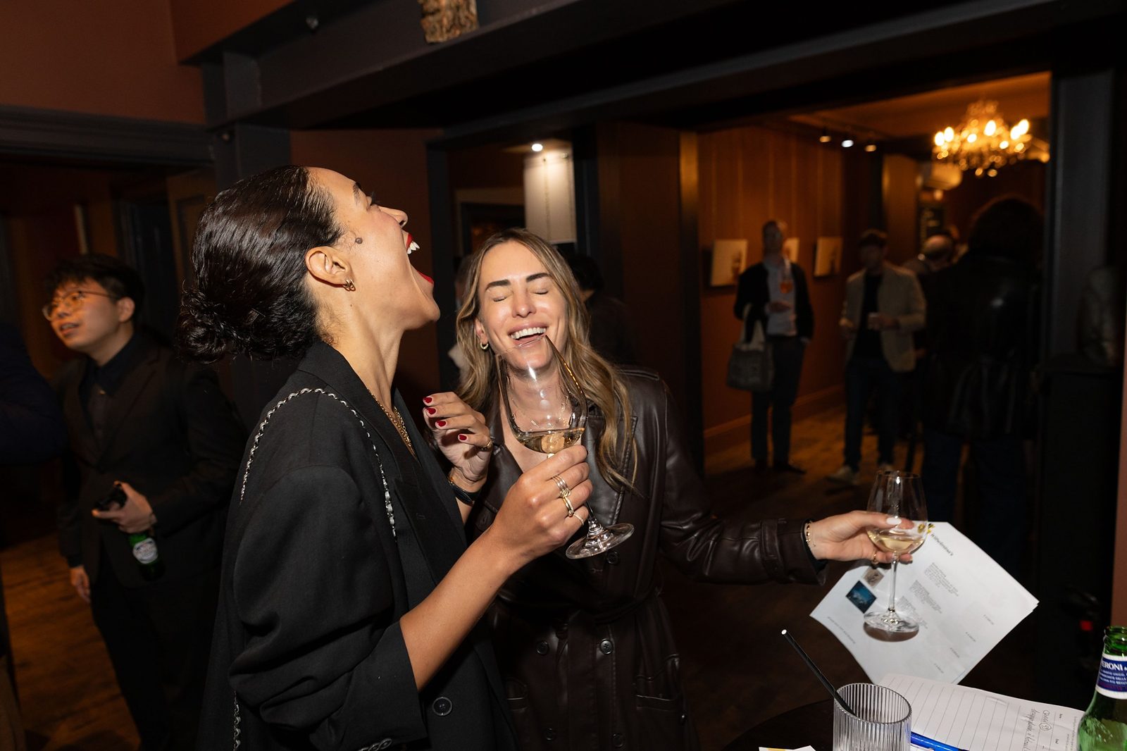 Guests laughing with glasses of wine at Adelphi Art House