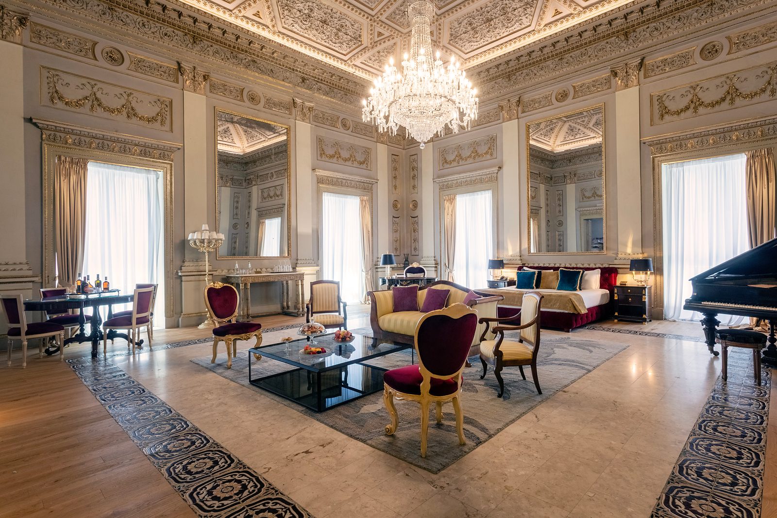 Richard Wagner Suite at Grand Hotel et des Palmes, with a chandelier, period furniture and a grand piano