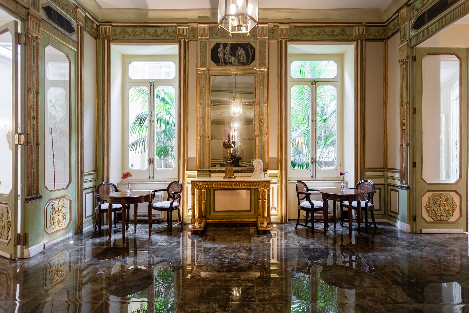 Sala Gattopardo at Grand Hotel et des Palmes, with gilded mirrors, a marble floor and tables by the windows