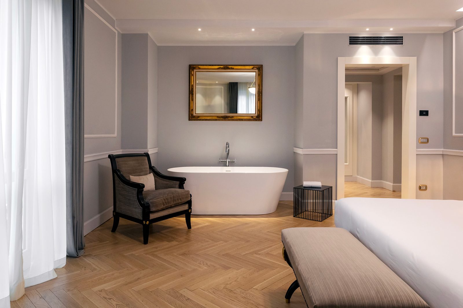 Prestige Room at Grand Hotel et des Palmes, with a freestanding bath and herringbone wooden floor