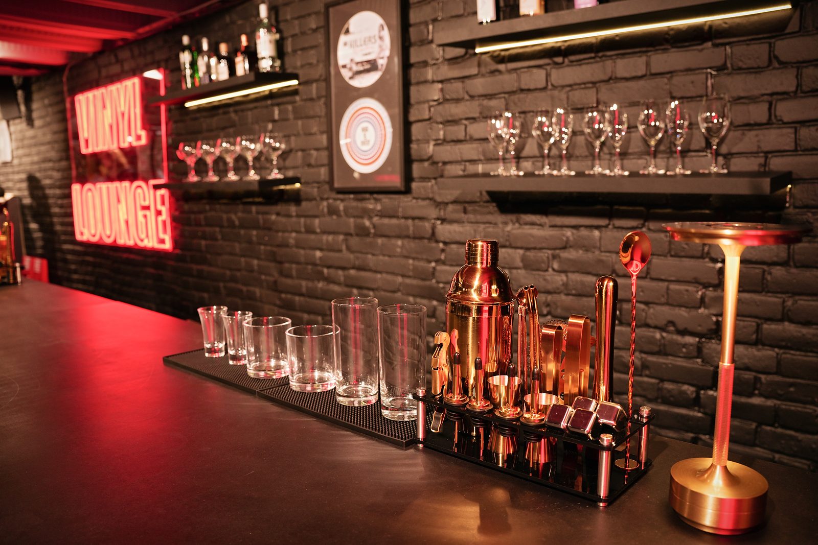 Cocktail tools, glassware and a table lamp on the bar at UMusic Shop Camden