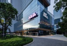 YOTEL signage on the glass facade of YOTEL Bangkok Sukhumvit at Cloud 11 in Bangkok, with Cloud 11 Hall alongside