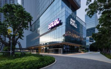 YOTEL signage on the glass facade of YOTEL Bangkok Sukhumvit at Cloud 11 in Bangkok, with Cloud 11 Hall alongside